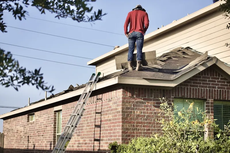 Professional roofer working on a residential roof in Chestnut Point